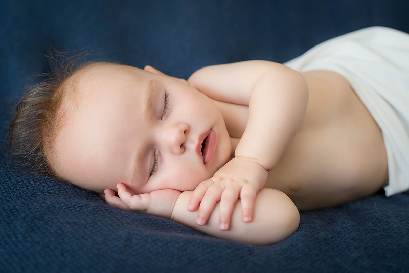 Sleeping baby on a navy blanket
