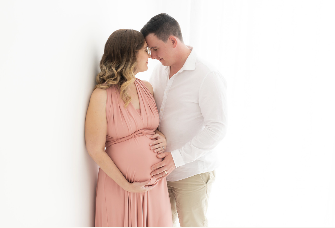 Maternity portrait at sunset, full body in a long field of grass